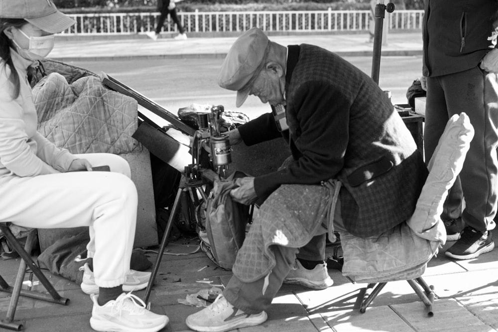 a black and white photo of people sitting on chairs