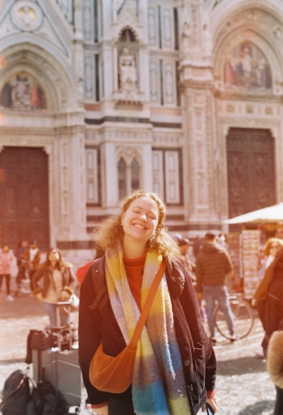 a woman standing in front of a large building