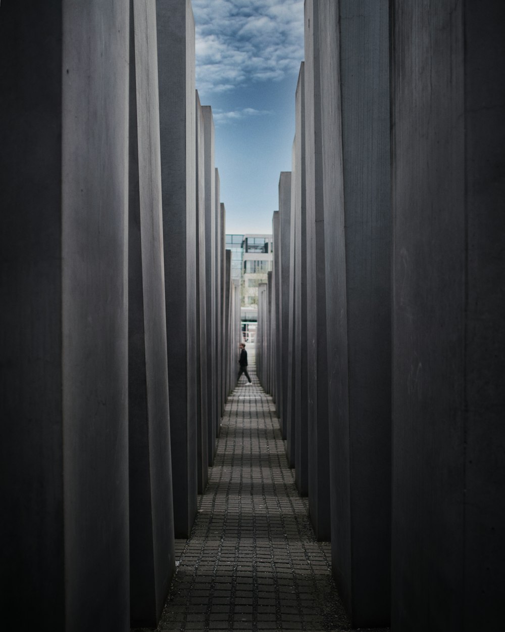 a person is walking through a tunnel of concrete