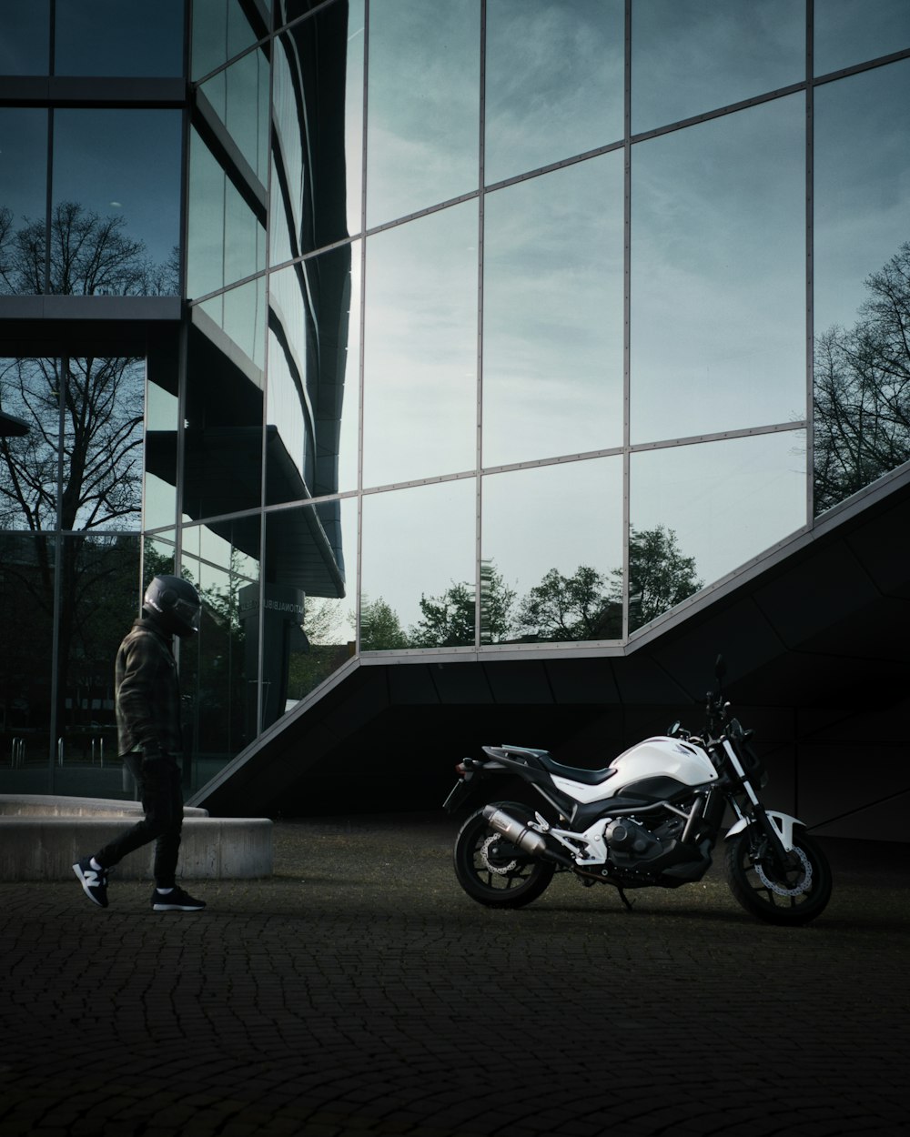 a motorcycle parked in front of a tall building