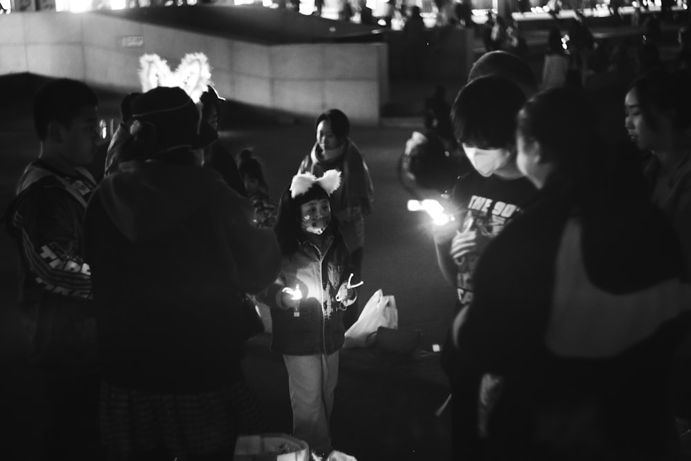 a group of people standing around each other