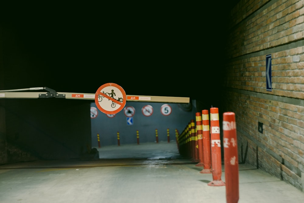 a tunnel with a sign and some orange traffic cones