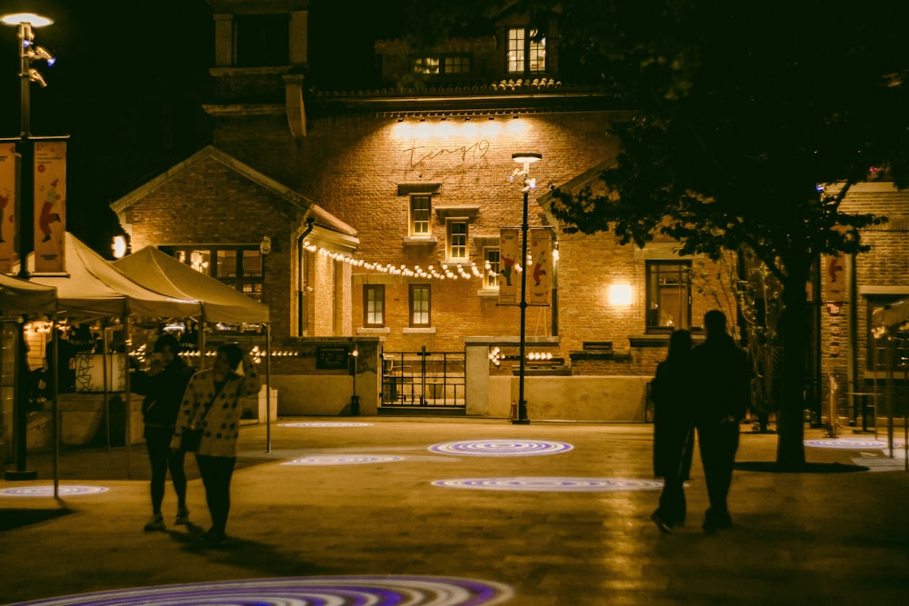 a couple of people standing in front of a building