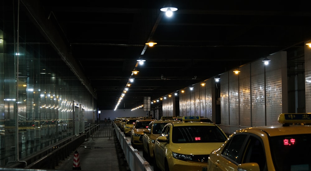 a row of taxi cabs parked in a parking garage
