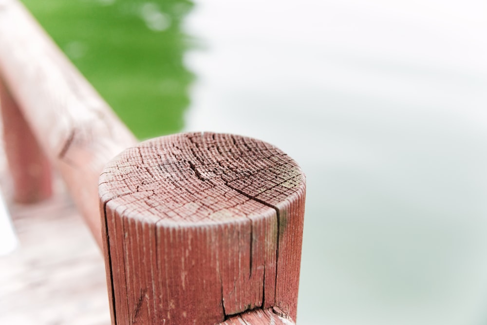 a wooden fence next to a body of water