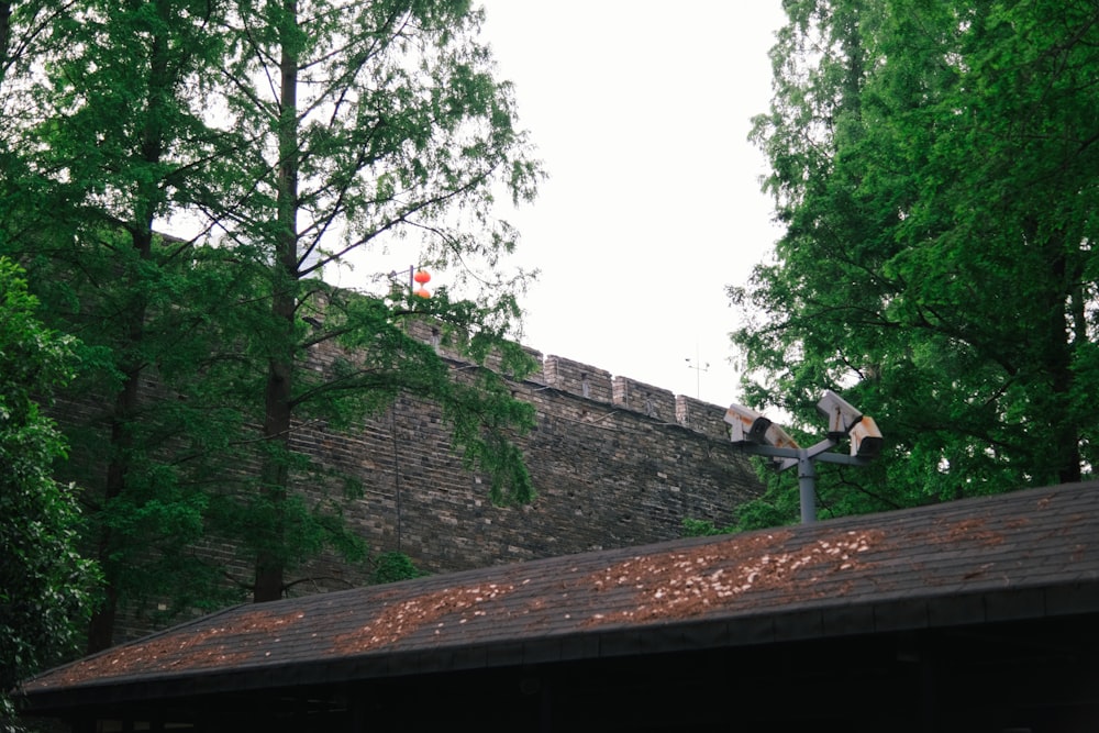 a brick wall and a roof with a roof vent