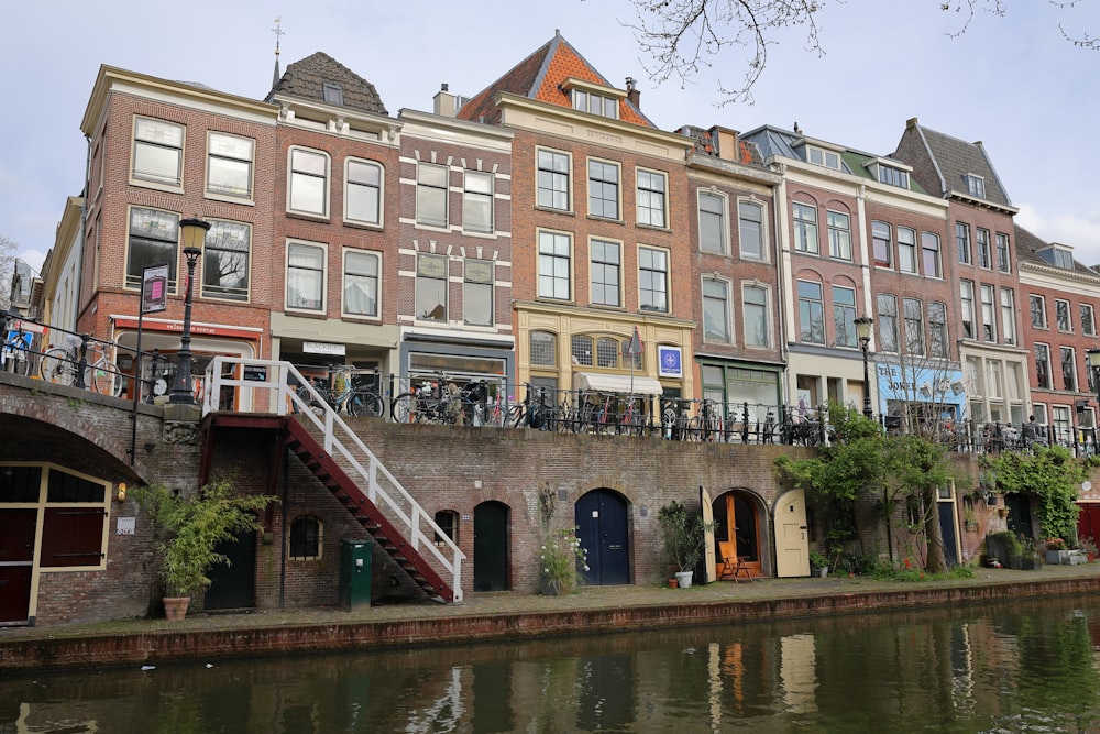 a row of buildings next to a body of water