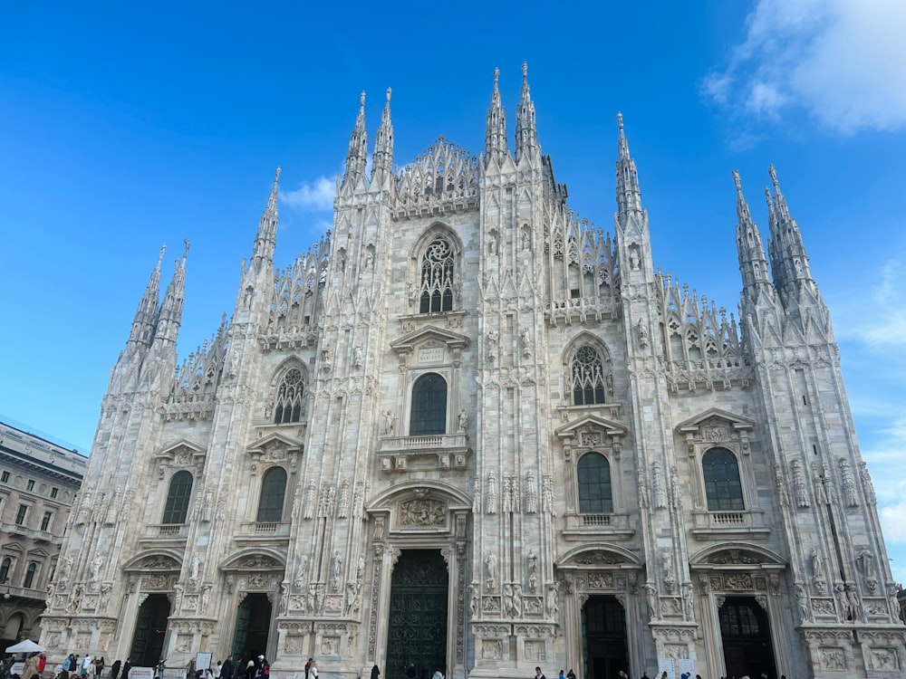 a large cathedral with many people walking around it