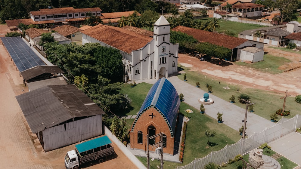 an aerial view of a church with a blue roof