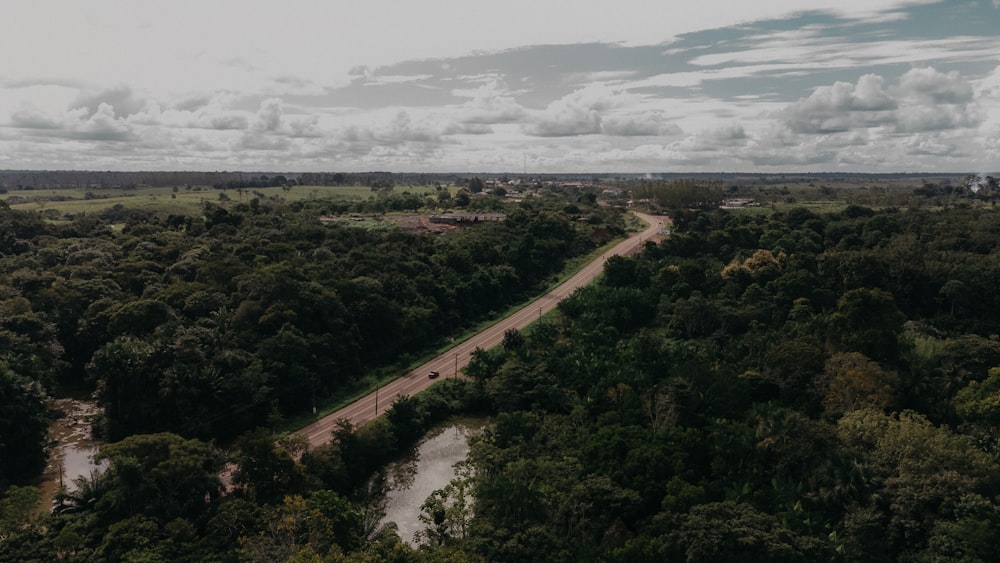 an aerial view of a road surrounded by trees