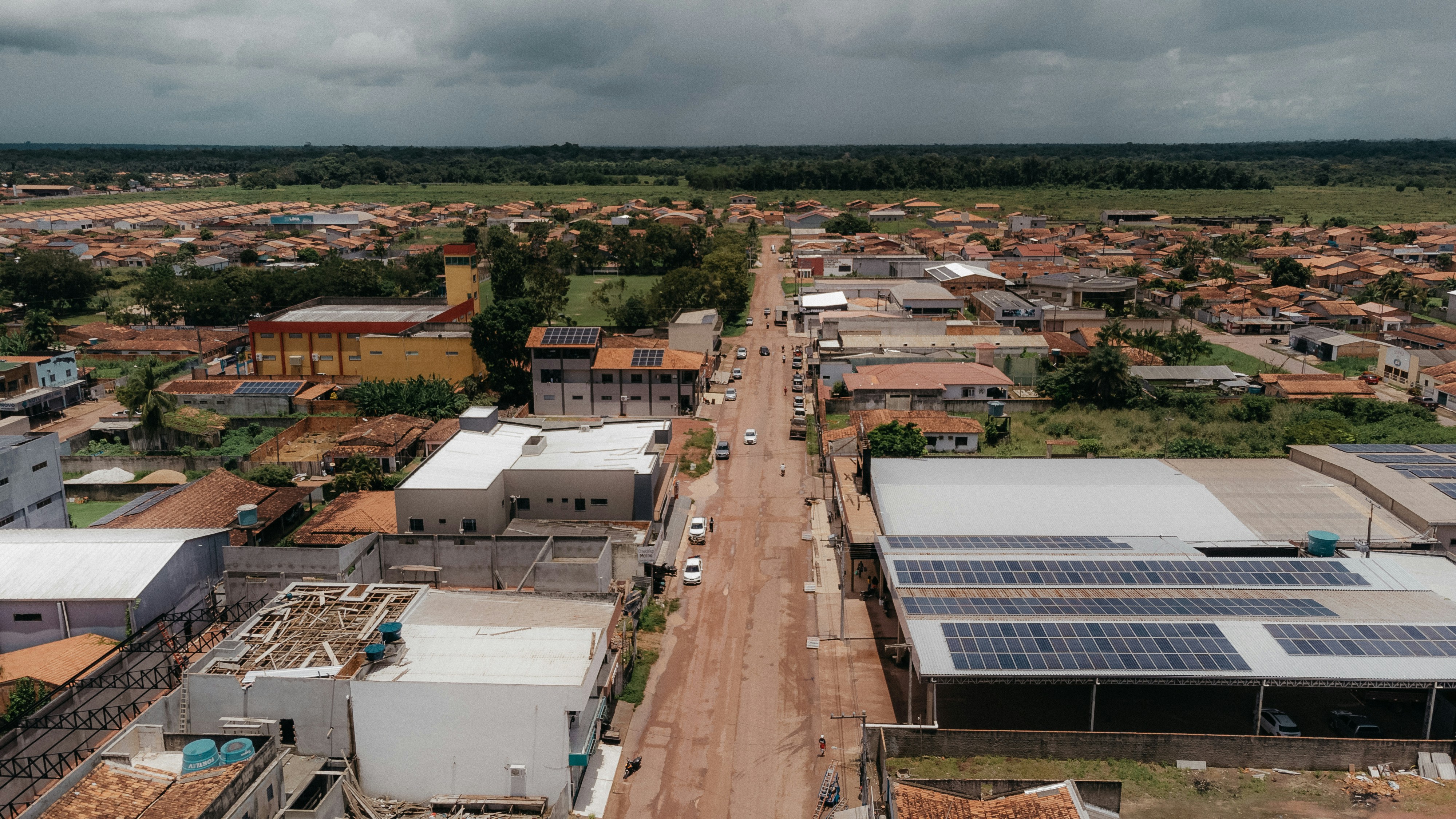 an aerial view of a small town with solar panels on the roof