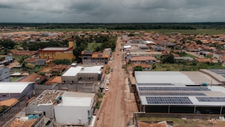 an aerial view of a small town with solar panels on the roof