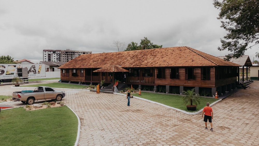 a man standing in front of a wooden building