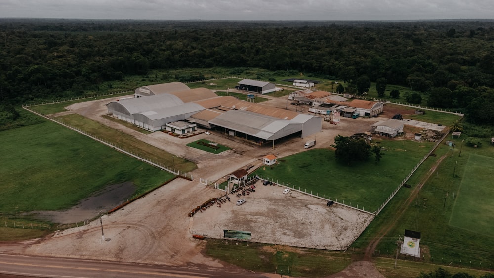 an aerial view of a farm with a large building