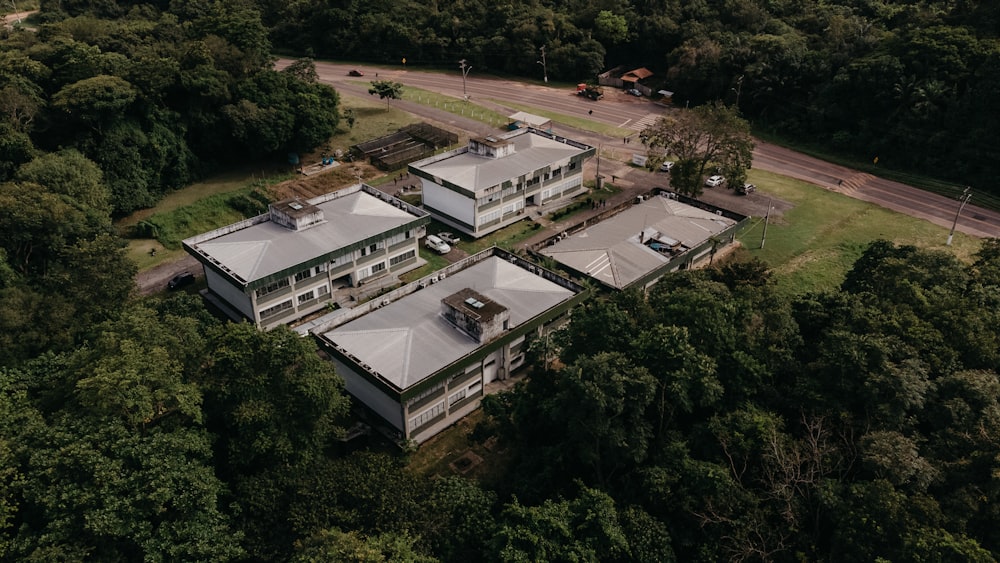 an aerial view of a building surrounded by trees