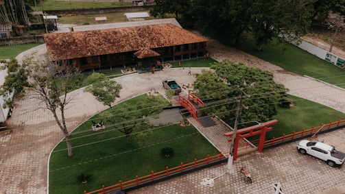 an aerial view of a building with a car parked in front of it