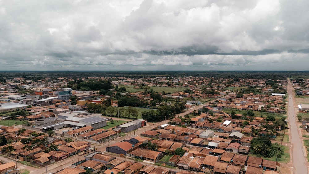 an aerial view of a small town under a cloudy sky