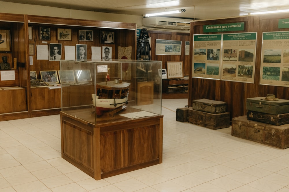 a room filled with suitcases and a display case