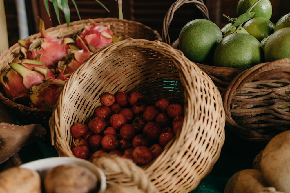 a table topped with baskets filled with fruit