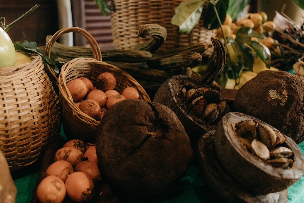 a table topped with baskets filled with fruit and vegetables