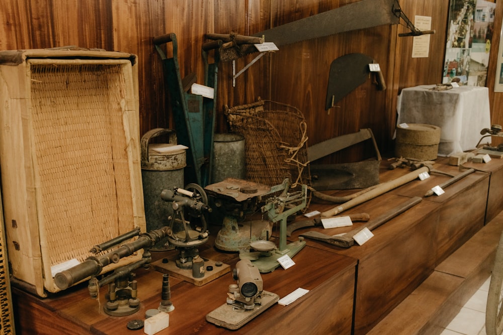 a collection of old tools on a wooden shelf