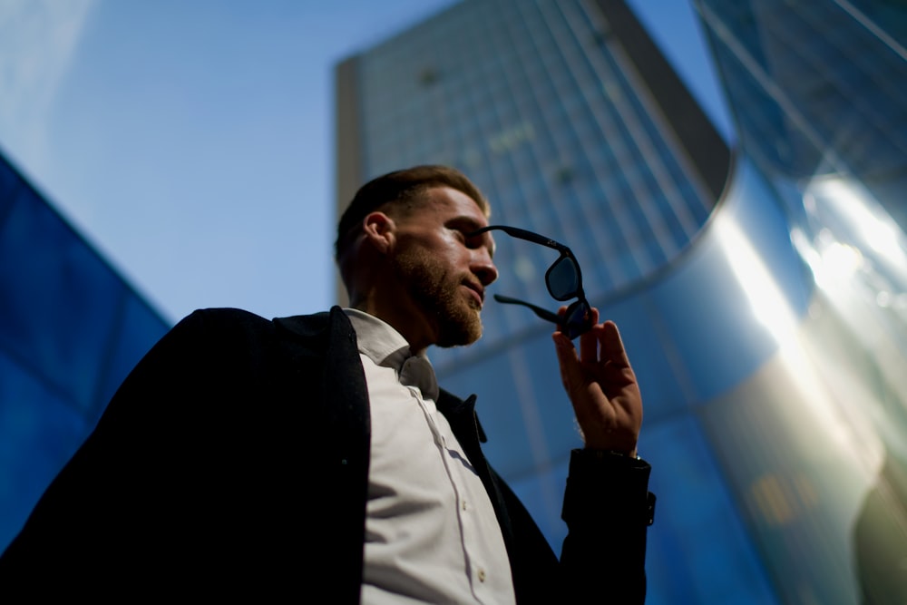 a man in a suit talking on a cell phone