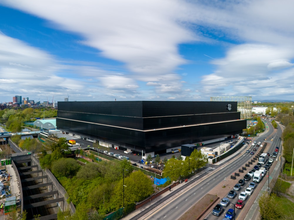 a large black building sitting on the side of a road