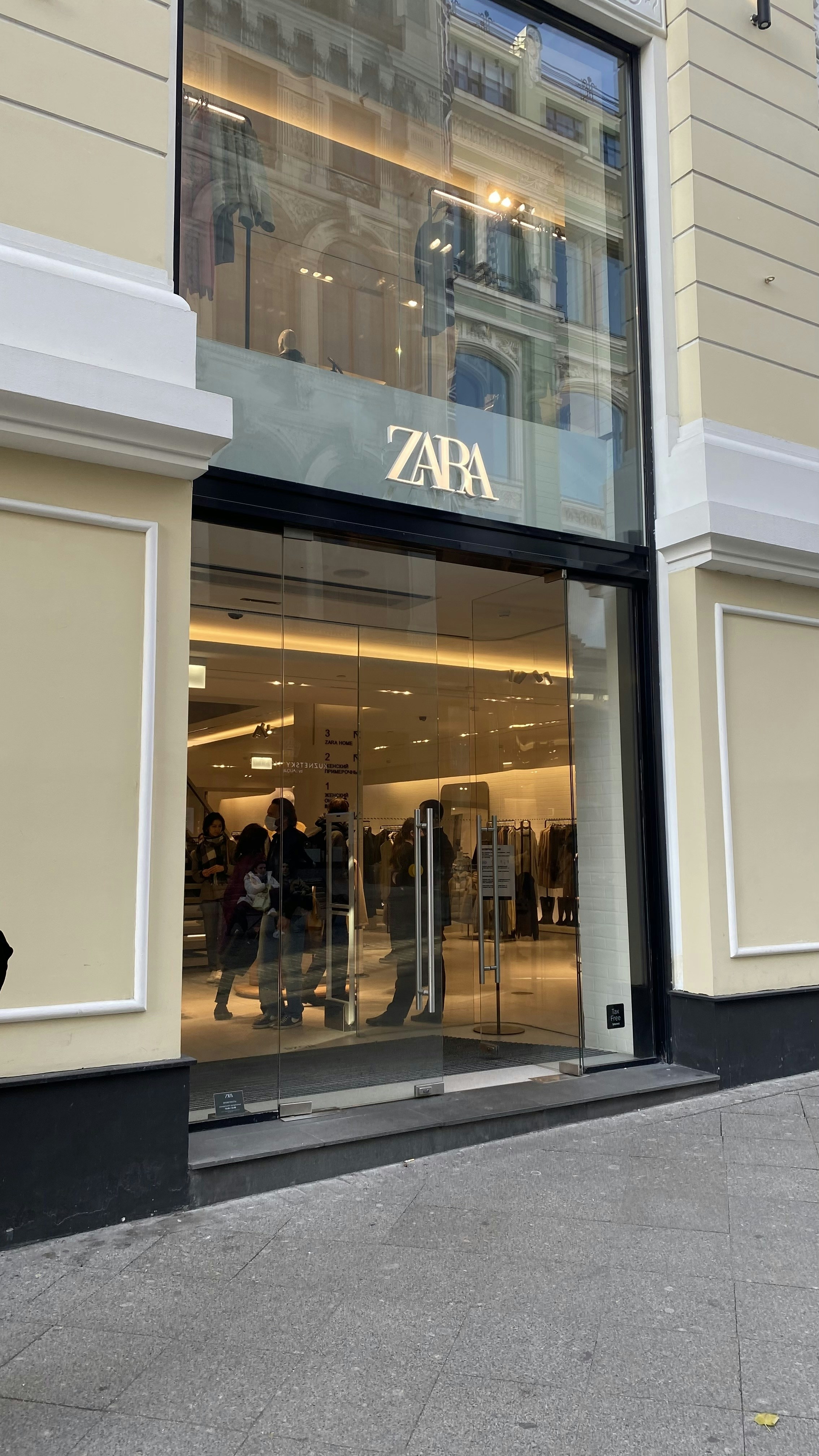 a group of people walking in front of a building