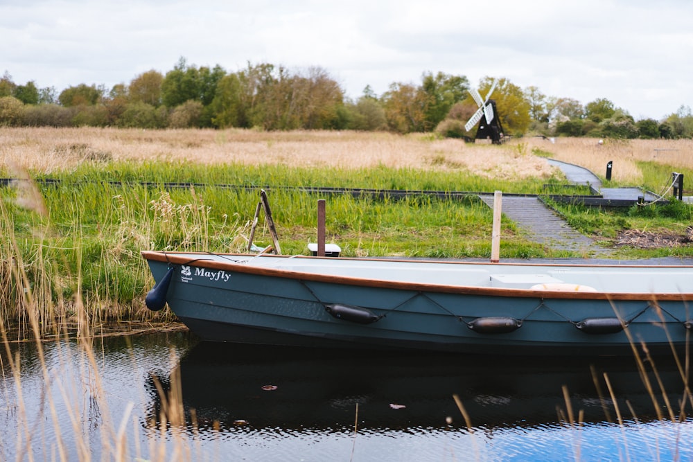 a small boat sitting on top of a body of water