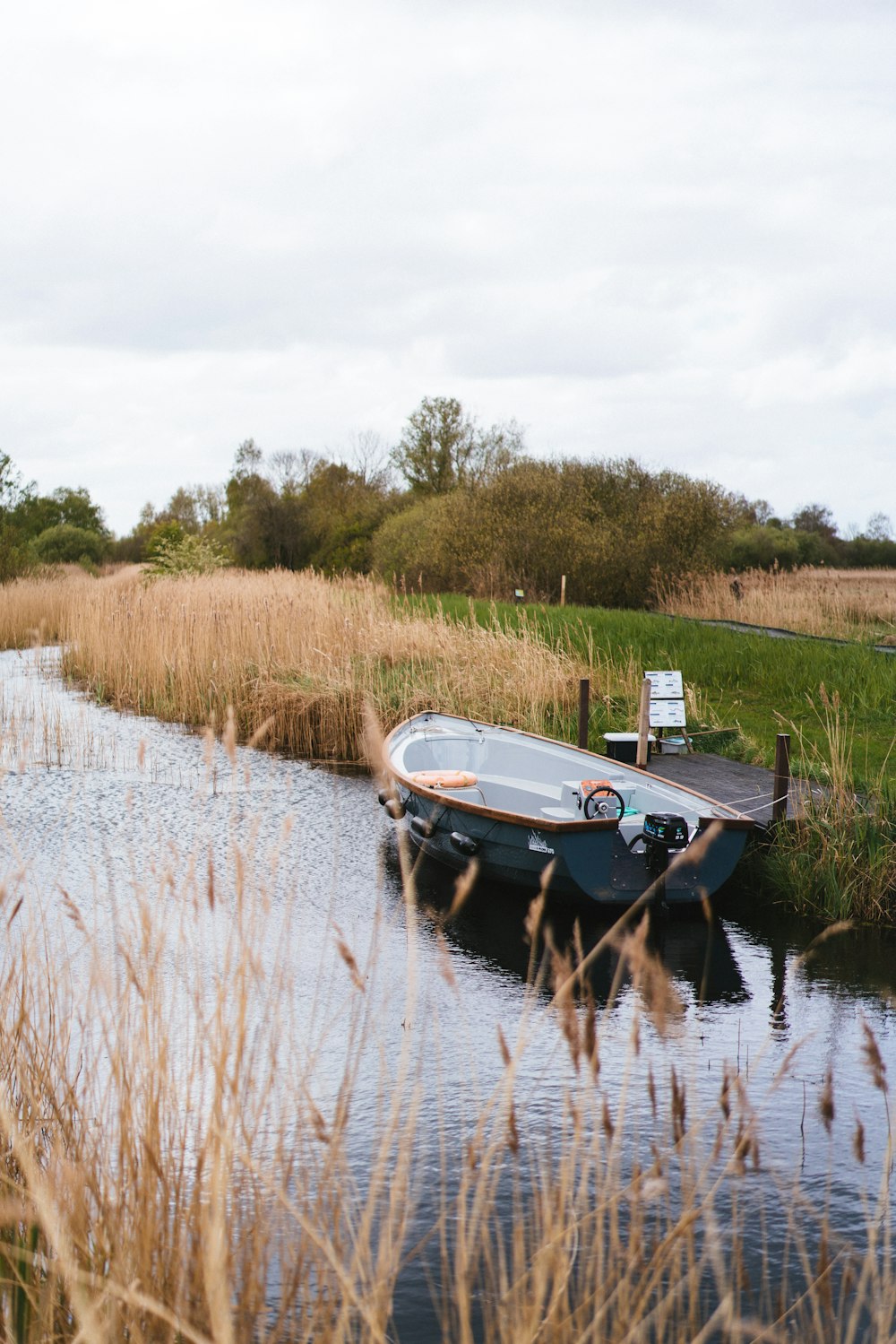 a small boat sitting on top of a body of water