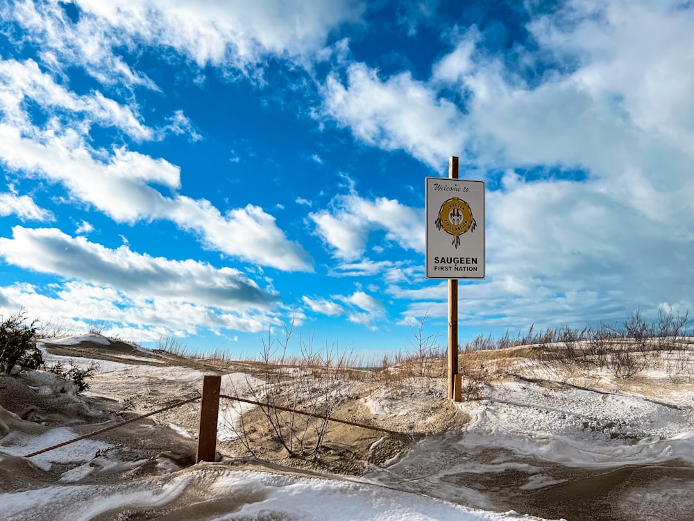 a sign in the middle of a snowy field