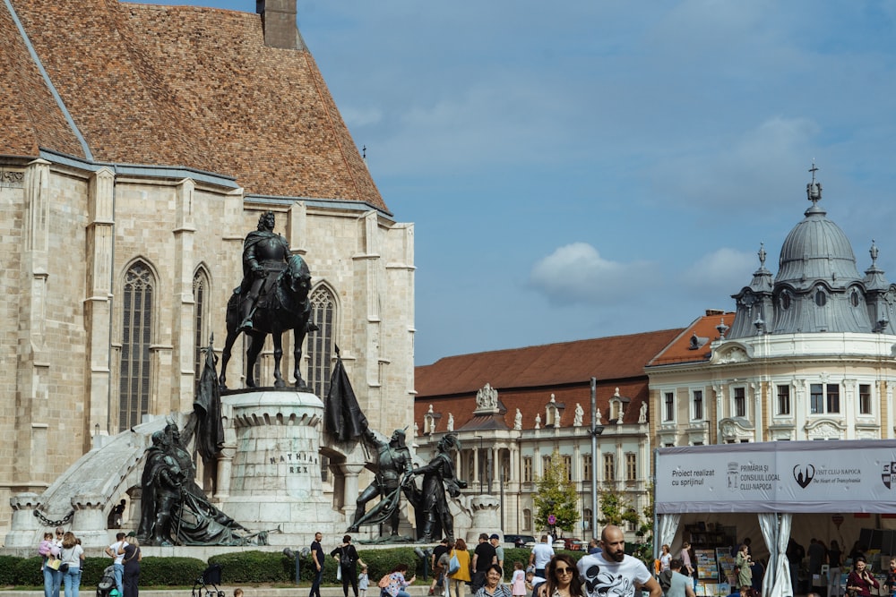 a statue of a man on a horse in front of a building