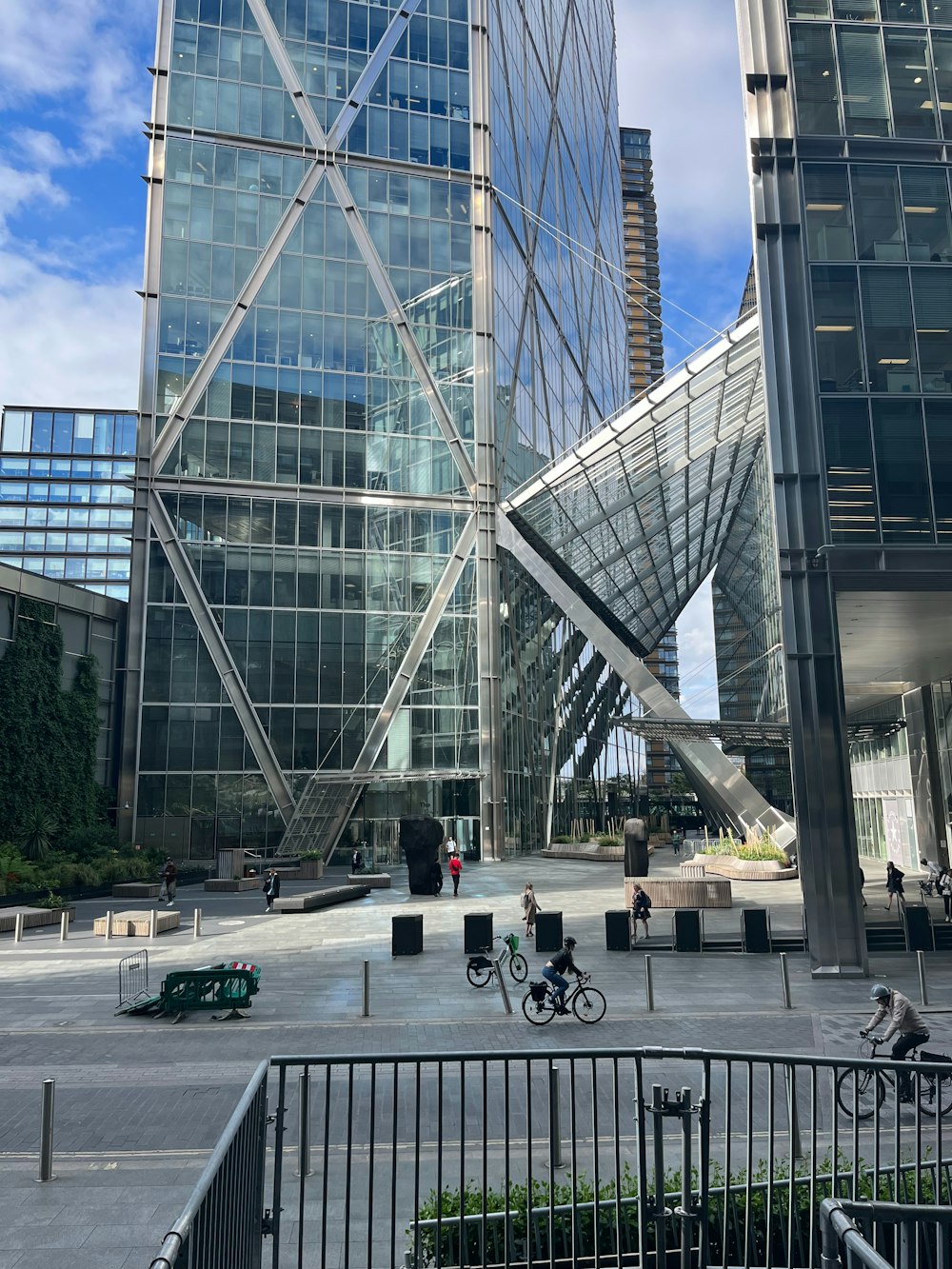 a group of people riding bikes in front of a tall building