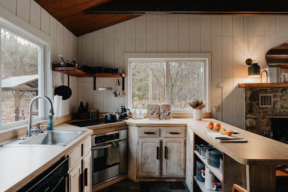 a kitchen with a stove, sink and a window