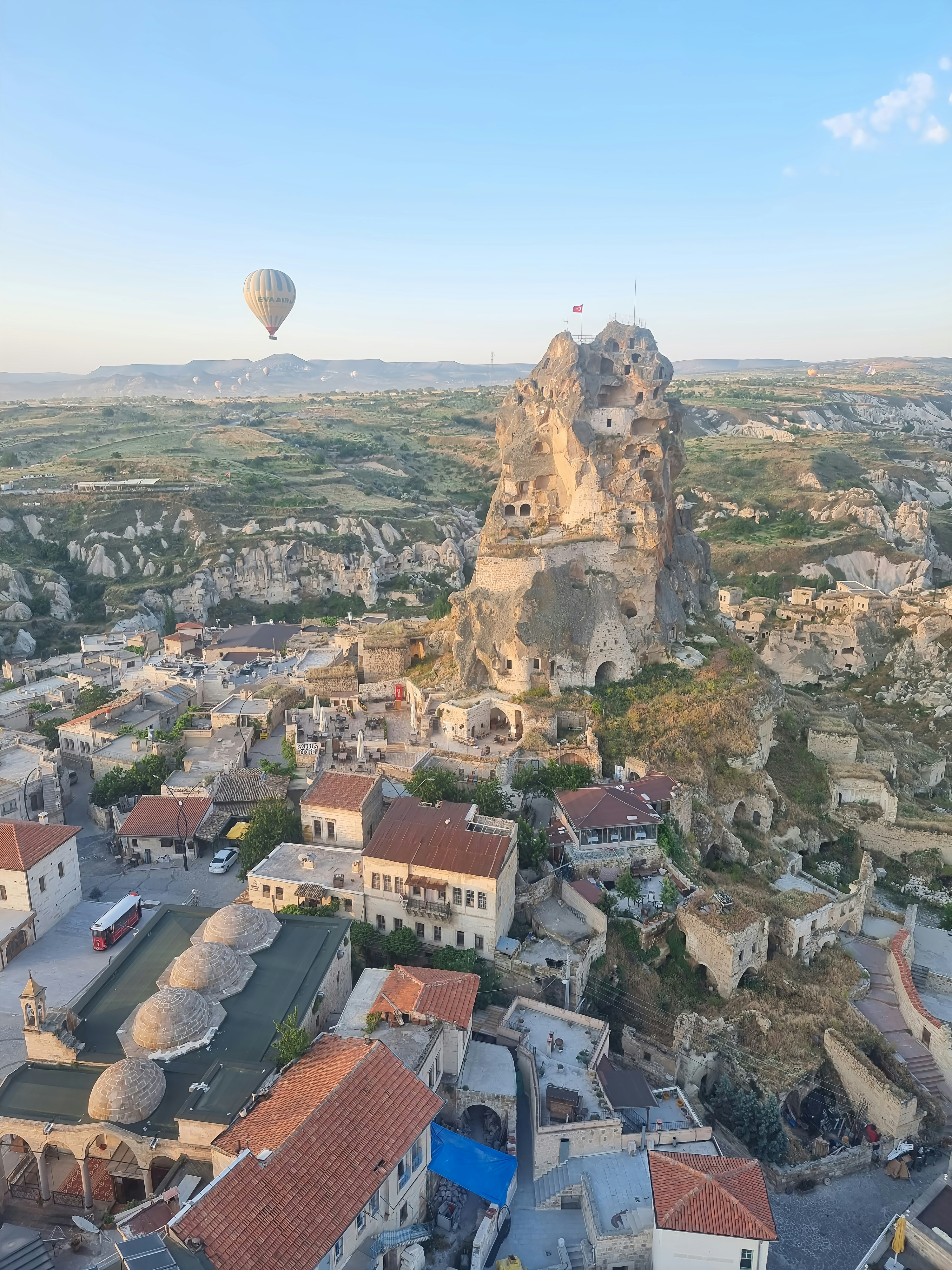 a hot air balloon flying over a city