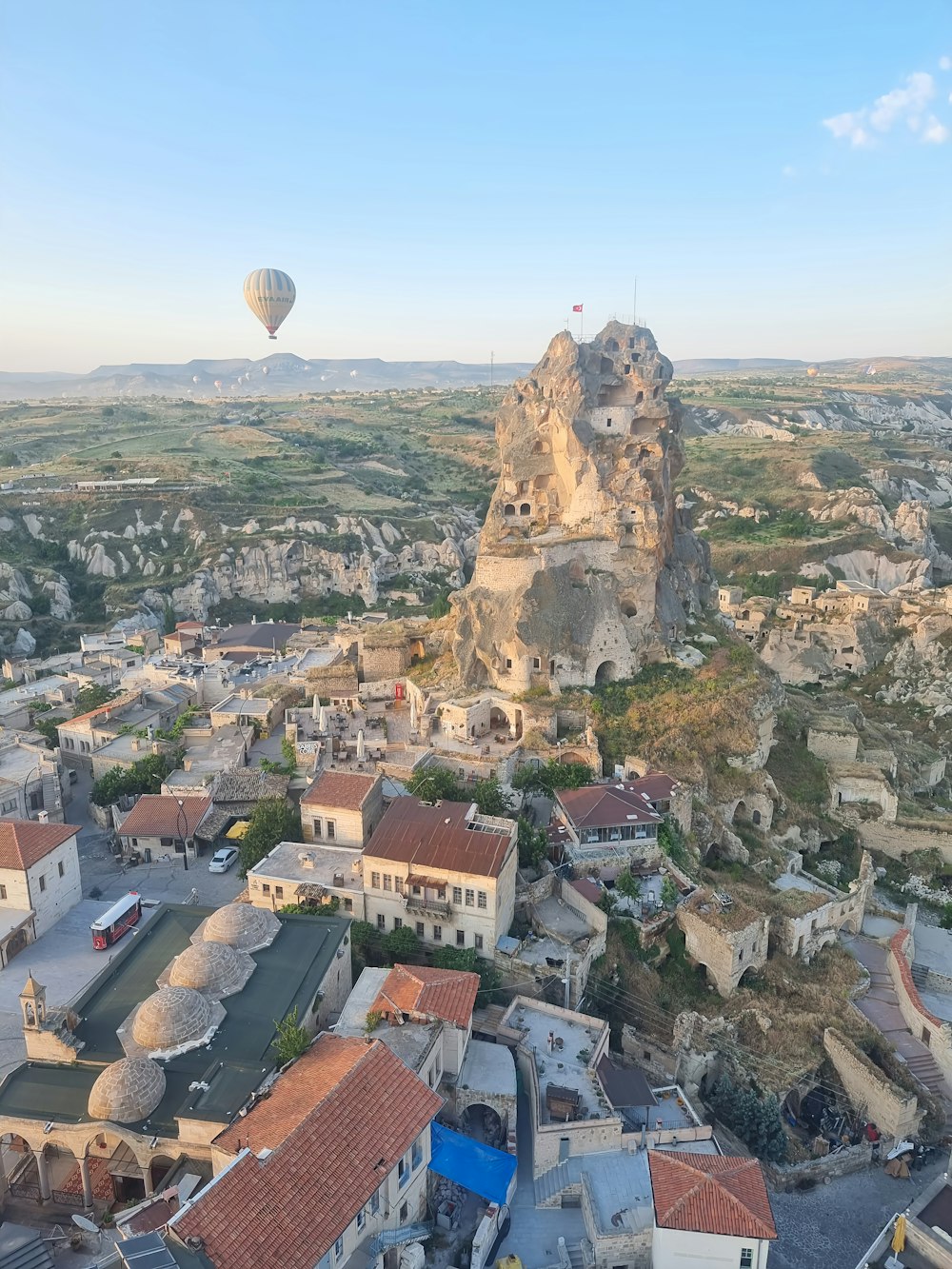 a hot air balloon flying over a city