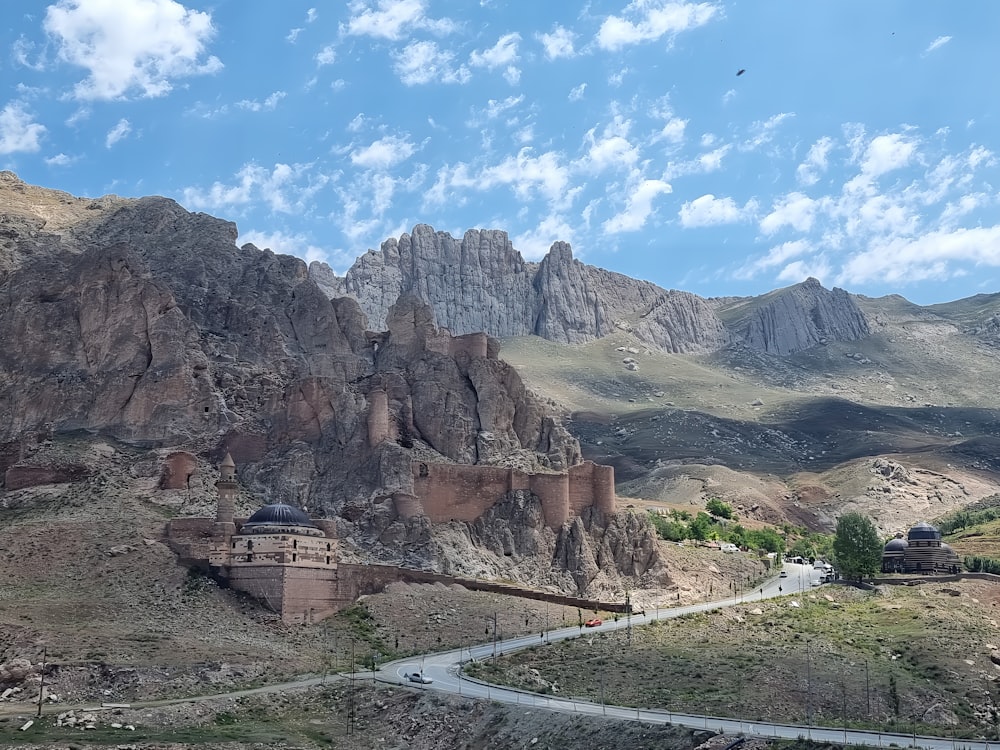 a scenic view of a mountain with a road going through it