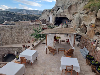 an outdoor dining area with tables and chairs