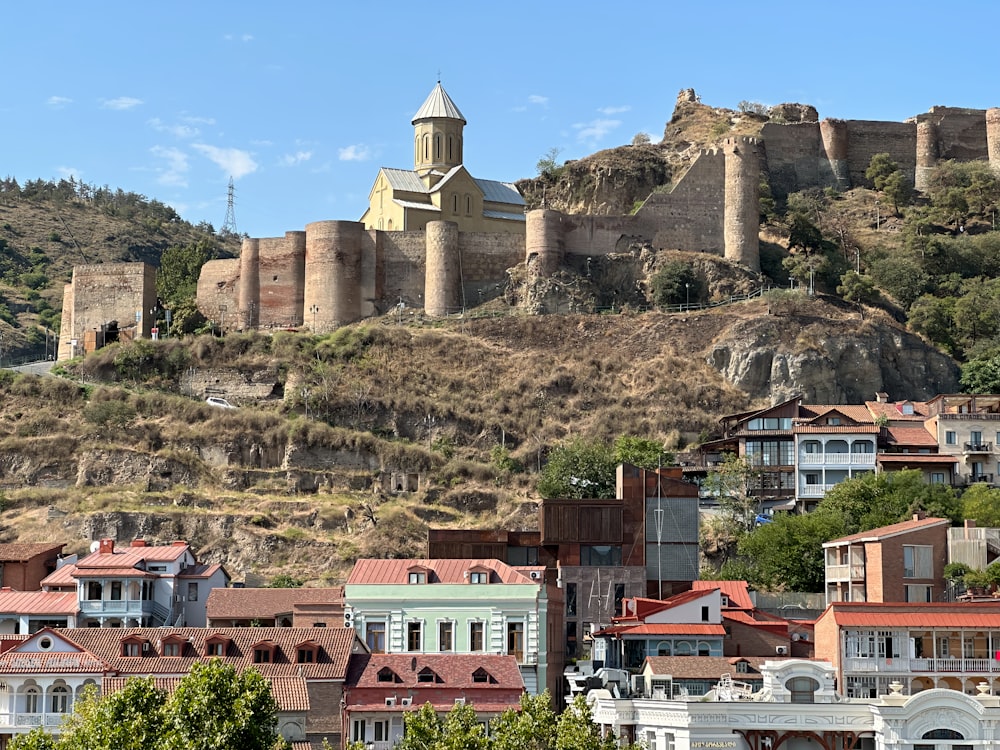 a city with a castle on top of a hill