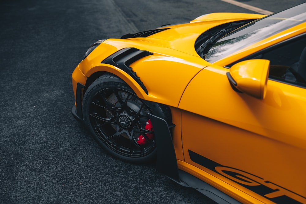 a yellow sports car parked in a parking lot