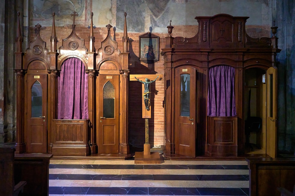 a set of wooden doors with purple curtains