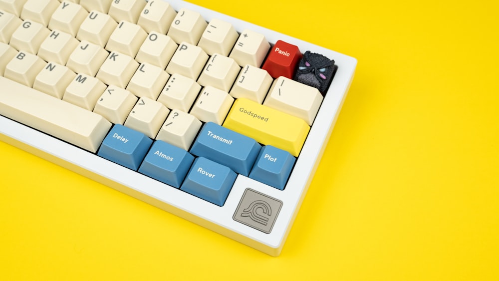 a computer keyboard sitting on top of a yellow table