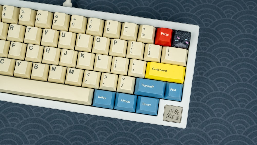 a computer keyboard with a yellow and blue key board