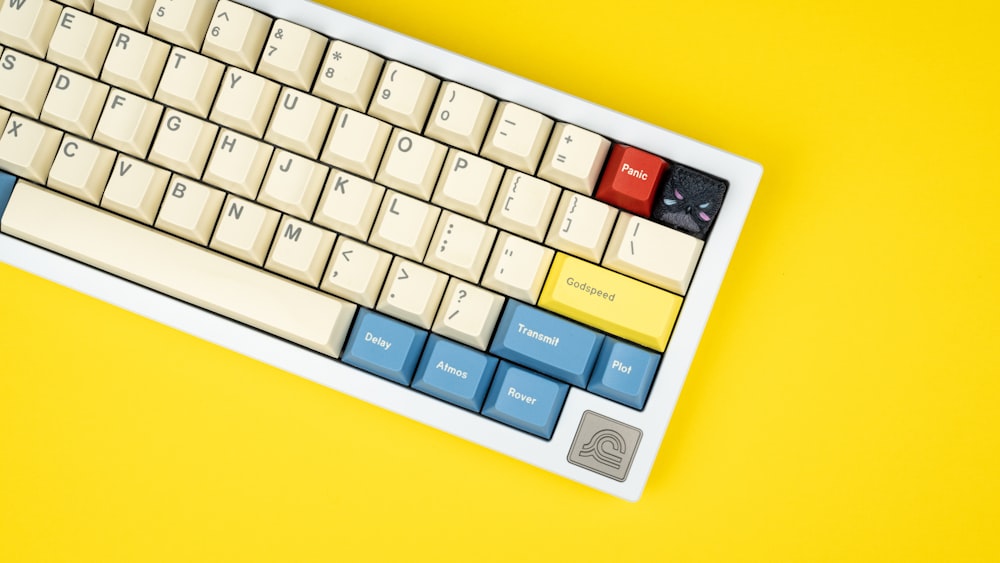 a computer keyboard on a yellow background