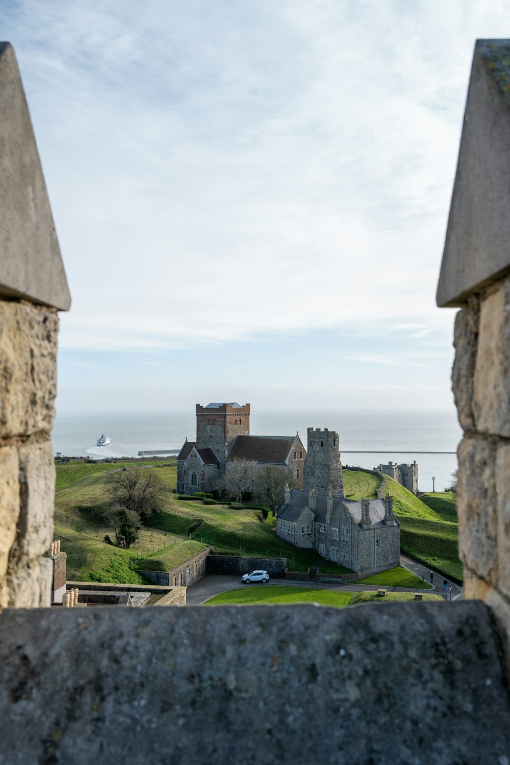 a view of a castle through a stone wall