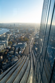 an aerial view of a city with a train on the tracks