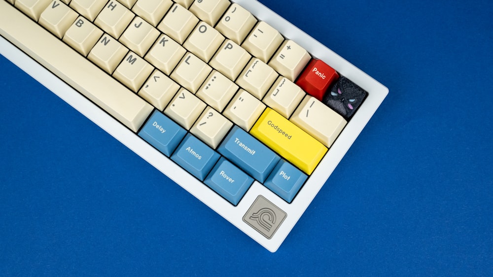 a computer keyboard with a yellow and blue key board