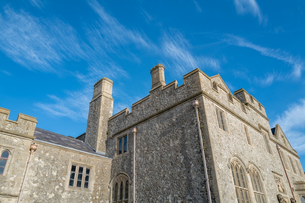 a large stone building with a clock on the front of it