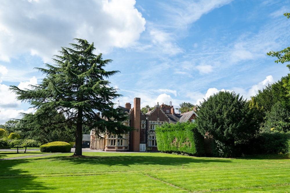 a large house sitting on top of a lush green field