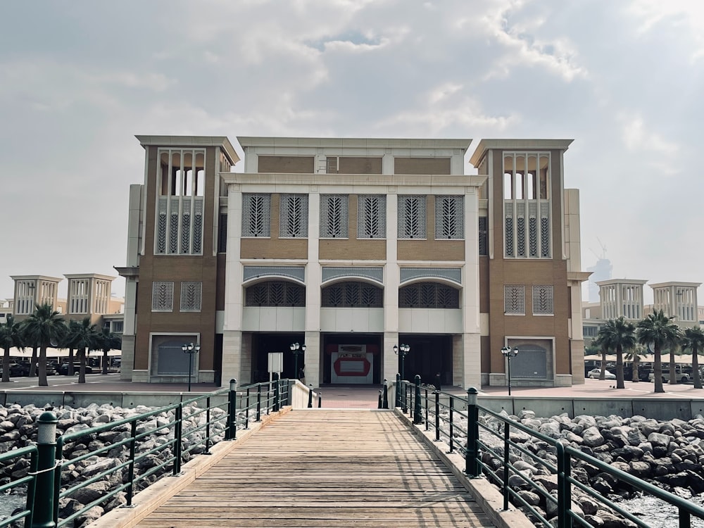 a large building with a wooden walkway leading to it